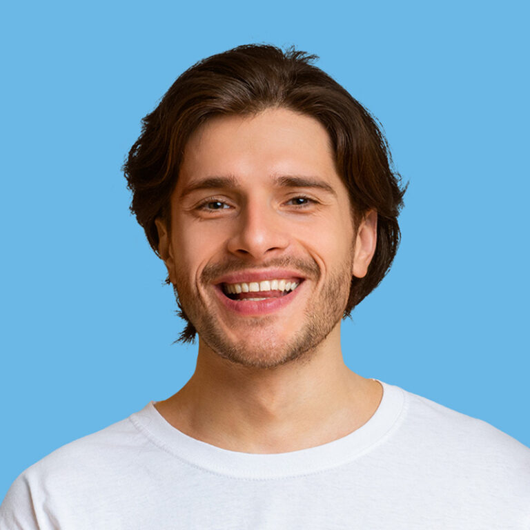 Smiling man with brown hair and a white t-shirt, looking refreshed and happy, reflecting the fresh results of Queen B Cleaning.