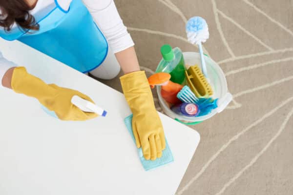 Person cleaning with yellow gloves